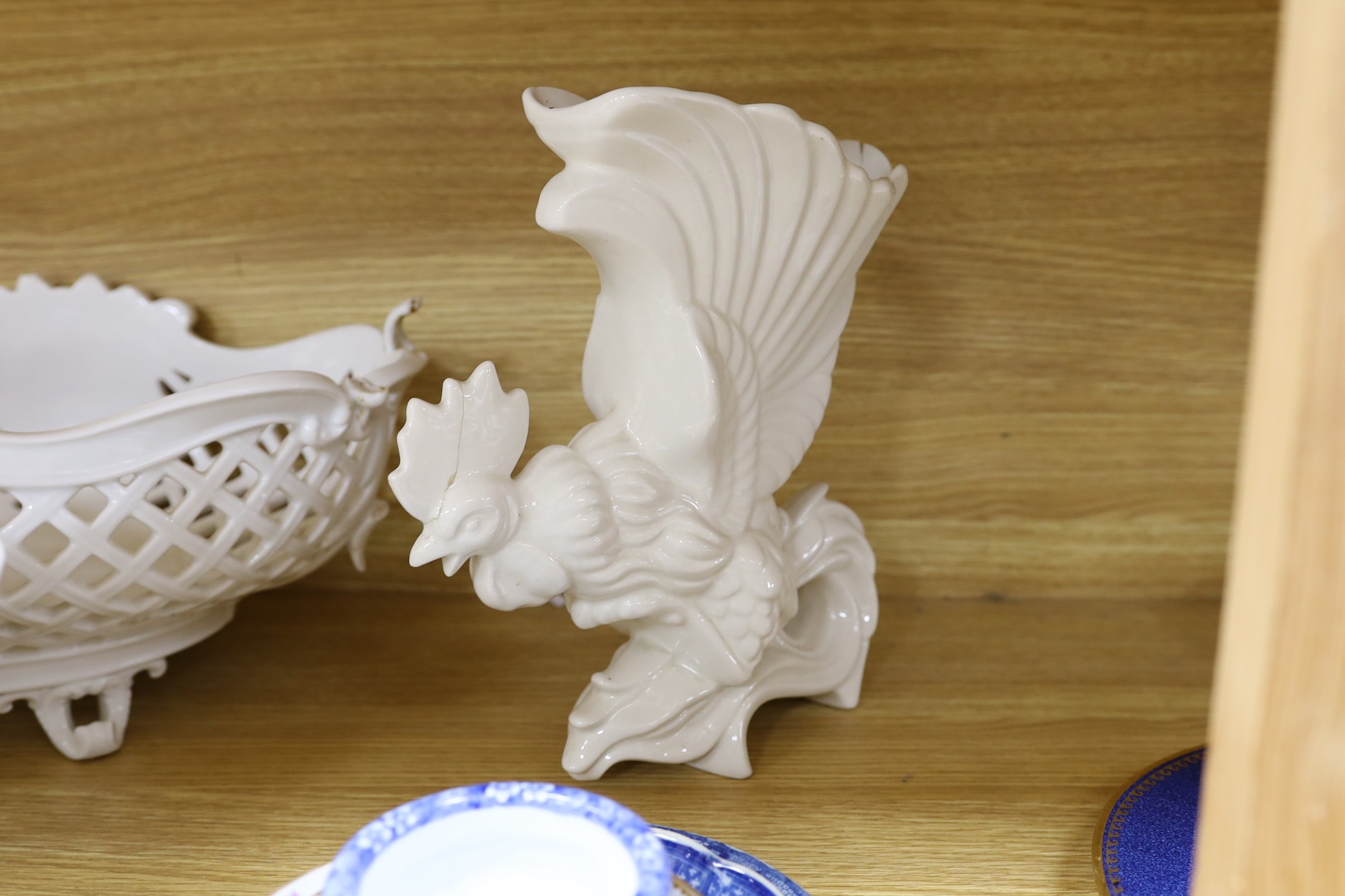 A group of Staffordshire blue and white pottery, including a sauce tureen and cover, together with a selection of decorative tea and dessert wares and ceramic centrepieces, one modelled as a cockerel